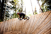 A downhill mountain biker on a wall ride in Wyoming., Jackson, Wyoming, USA