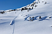 A athletic young man snowmobiling high marks on a untracked mountain in Montana., Bozeman, Montana, USA