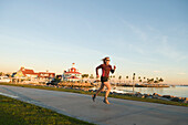 A woman running along the Long Beach Boardwalk, Long Beach, California., Long Beach, California, usa