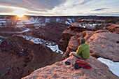 Male hiker watching the sunset from Dead Horse Point State Park, Moab, Utah., Moab, Utah, usa