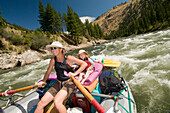 A mother and daughter rowing a raft through a rapid, Main Salmon River, Payette National Forest, Riggins, Idaho., Riggins, Idaho, usa