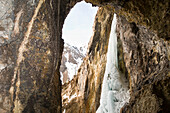 A woman ice climbing a frozen waterfall, Silverton, Colorado., Silverton, Colorado, usa