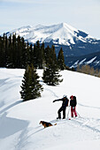 Two snow hikers with their dog., Crested Butte, Colorado, usa