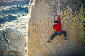 Man bouldering on an overhang, Buttermilk Boulders, California, United States