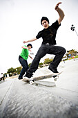 Two skateboarders do tricks at a skatepark Carlsbad, California, United States