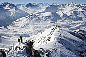 Two young men hike from the top of Valuga Peak to ski off-piste in St. Anton am Arlbeg, Austria St. Anton am Arlberg, Arlberg, Austria