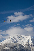 Cable cars hang high above the snowy ground near Mayrhofen, Austria Mayrhofen, Tyrol, Austria