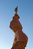 Woman of top of sandstone spire, Fisher Towers, Utah Moab, Utah, USA