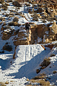 Mountain biker jumping with snowy landing in Moab, Utah Moab, Utah, USA