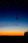 A ski lift in front of a blue and orange sunset Oregon, USA