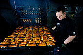 Smoke House Thurow, Joachim Thurow with a tray of smoked Salmon, Fish, Freest, Mecklenburg-Vorpommern, Germany