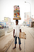 Merchant carrying a mobile kiosk, Ganxi, Cotonou, Benin