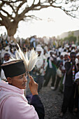 Group of believers around a meeting tree, priest with horsehair frond in foreground, Axum, Tigray Region, Ethiopia