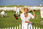 Young woman playing croquet, Cape Cod, MA