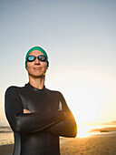Hispanic woman wearing wetsuit and goggles, Newport Beach, CA