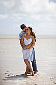 Hispanic couple hugging at beach, Miami, FL