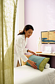 Asian female doctor preparing treatment table, Gaithersburg, MD