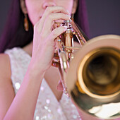 Hispanic woman playing trumpet, Jersey City, NJ