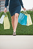Hispanic woman carrying shopping bags, New Jersey