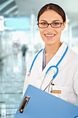 Mixed race doctor holding medical chart in hospital, Cape Town, South Africa