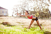 Mixed race woman warming up before exercise, Seattle, WA, USA