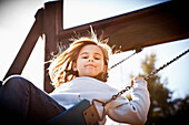 Caucasian girl swinging, San Anselmo, California, USA
