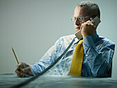 Caucasian businessman covered in cobwebs talking on telephone, Villanova, Monza Brianza, Italy