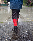 Caucasian boy walking in the rain, Torrance, California, United States