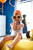 Mixed race girl at party wearing sunglasses, San Diego, California, United States