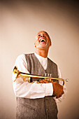 Laughing musician holding trumpet, Rockville, Maryland, USA
