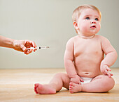 Doctor giving Caucasian baby injection, Jersey City, New Jersey, United States