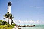 Lighthouse and tropical palm trees near ocean, Key Biscayne, Florida, United States