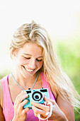 Caucasian woman holding camera, Heber, Utah, USA