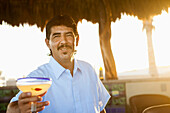 Hispanic bartender serving cocktail, Zacatitos, Baja California Sur, Mexico