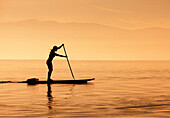 Caucasian woman standing on paddle board, Salt Lake City, Utah, USA