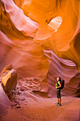 Persian woman hiking in canyon, Page, Arizona, USA