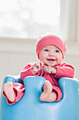 Smiling Caucasian baby sitting in chair, Tallahassee, Florida, USA