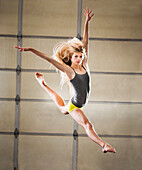 Caucasian dancer leaping in studio, Orem, Utah, USA