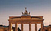 Columned building and statue lit up at night, Berlin, Germany, Berlin, Germany, Europe