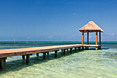 Pier over turquoise blue water on the beach at Cancun, Cancun, Quintana Roo, Mexico