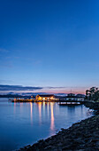 Illuminated buildings on water at dawn, Paihia, Paihia, new zeland