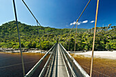 Suspension bridge over tropical beach, Kohaihai, Kohaihai, new zeland