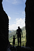 Caucasian mother and son exploring cave, Jackson, Wyoming, USA