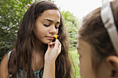 Mixed race girls smelling flowers, Norfolk, Virginia, USA