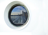 City skyline reflected in ferry porthole, Seattle, Washington, United States, Seattle, Washington, USA