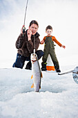 Caucasian father and son ice fishing, Heber, Utah, USA