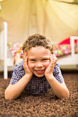 Caucasian boy smiling in bedroom, Lehi, Utah, USA