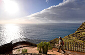 Woman hiking along coastal trail, Tijarafe, La Palma, Canary Islands, Spain