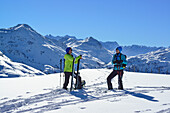 Two female back-country skiers having a rest at Steinberg, Kitzbuehel Alps, Tyrol, Austria