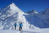 Two female backcountry skiers ascending to Kuhscheibe, Stubai Alps, Tyrol, Austria